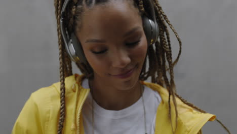 beautiful-young-mixed-race-woman-listening-to-music-wearing-headphones-smiling-happy-enjoying-carefree-lifestyle-close-up