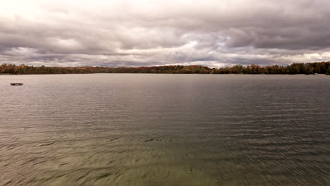 Low-on-lake-to-rise-up-drone-footage-where-we-see-grand-traverse-bay