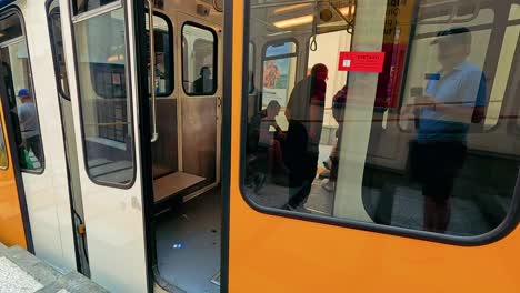 people entering train at naples subway station