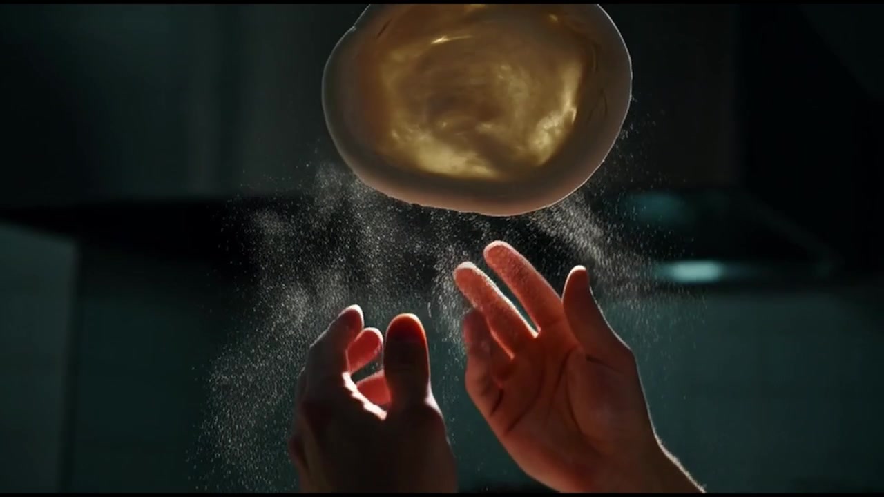 Professional Chef Stretching and Tossing Pizza Dough in Kitchen