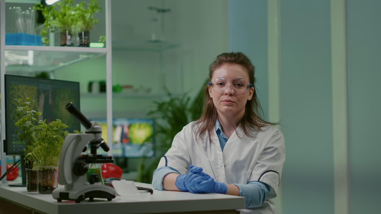 Pov of botanist woman in white coat listening chemists team during online videocall
