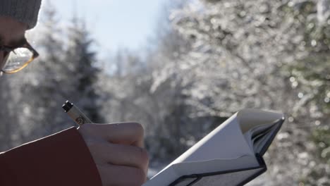 Hombre-Científico-En-Un-Bosque-De-Invierno-Tomando-Notas-Para-La-Investigación-De-Campo