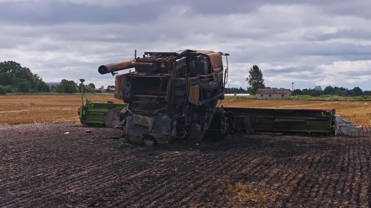 Destroyed harvester in field as symbol of food insecurity in conflict zones