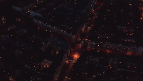 Orbit-footage-around-busy-crossroad.-Aerial-view-of-cars-driving-into-night-streets-of-town.-Berlin,-Germany.