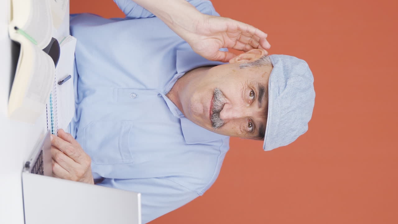 Vertical video of A old man with a hearing problem.