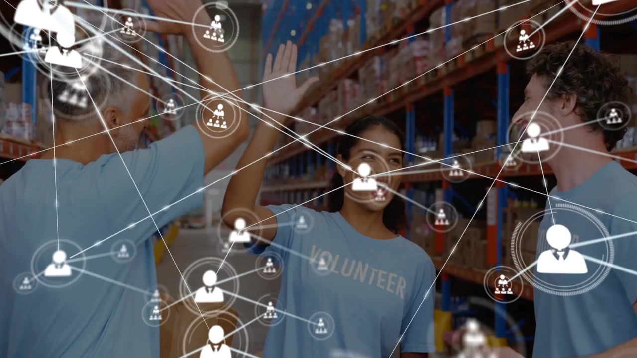 Diverse Volunteers High-Fiving in Warehouse with Digital Network Overlay