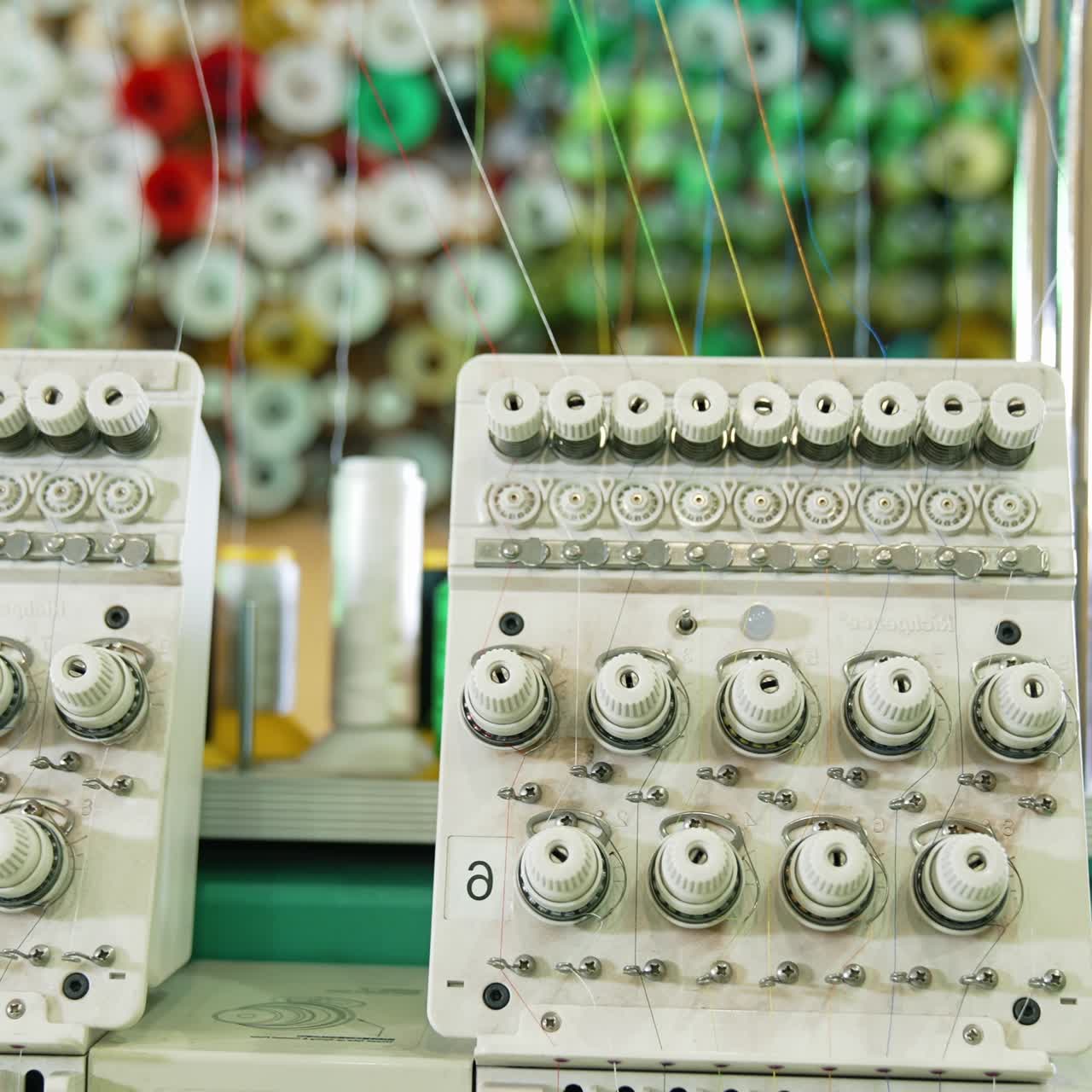 Modern sewing machine full of threads. Awesome factory sewing machine