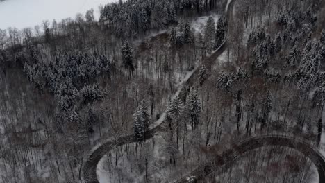 Look-up-shot-of-a-drone-to-the-winding-street-with-the-travel-destination-"Abbey-Schäftlarn"-at-the-wonderful-winter-season