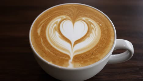latte,coffee,art,heart,design,cappuccino,creamer,milk,foam,beverage,caffeine,espresso,barista,brew,cup,white,smoothing,texture,pattern,warm,drink,taste,aroma,bistro,comfort,morning,cafe,warmth,refreshing,artistry,rich,indulgence,presentation,table,coffee shop,enjoy,sip,moment,experience,visual