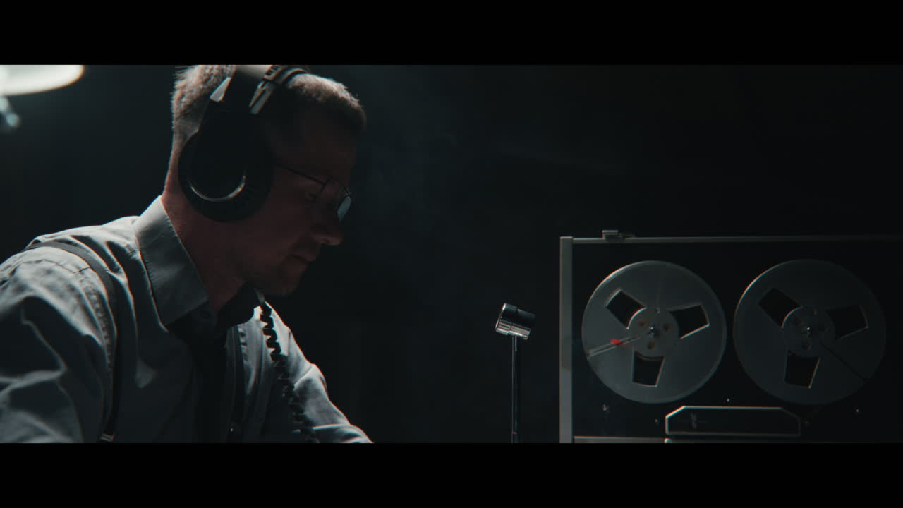 An intelligence officer listens to the wiretap recordings