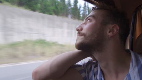 young man sitting in the back seat of the vehicle.