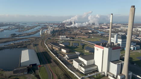 Aerial-overview-of-large-polluting-industrial-terrain---drone-flying-backwards