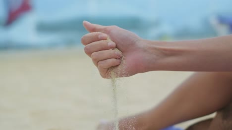 sand-pouring-from-the-woman's-palm-on-the-beach
