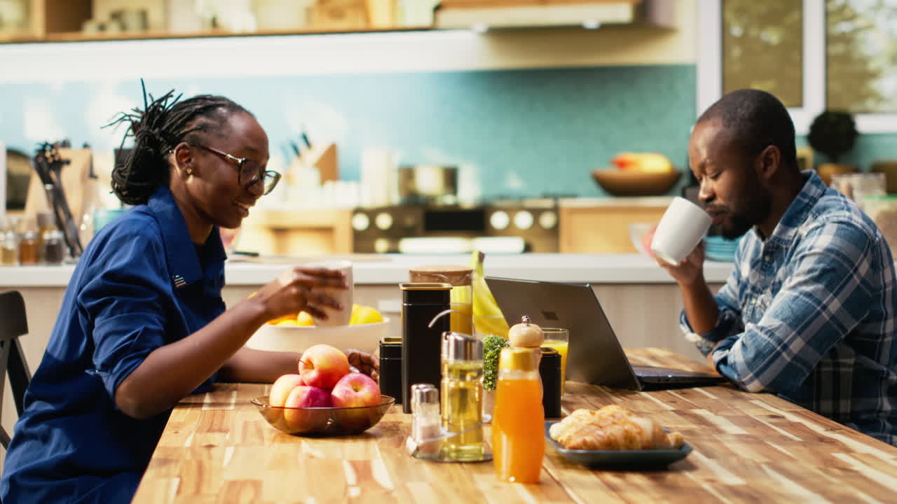 People eating breakfast at a wooden table