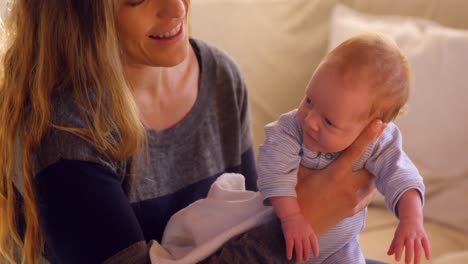 Mother-comforting-her-baby-in-living-room-4k