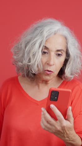 senior woman's surprised reaction to smartphone content