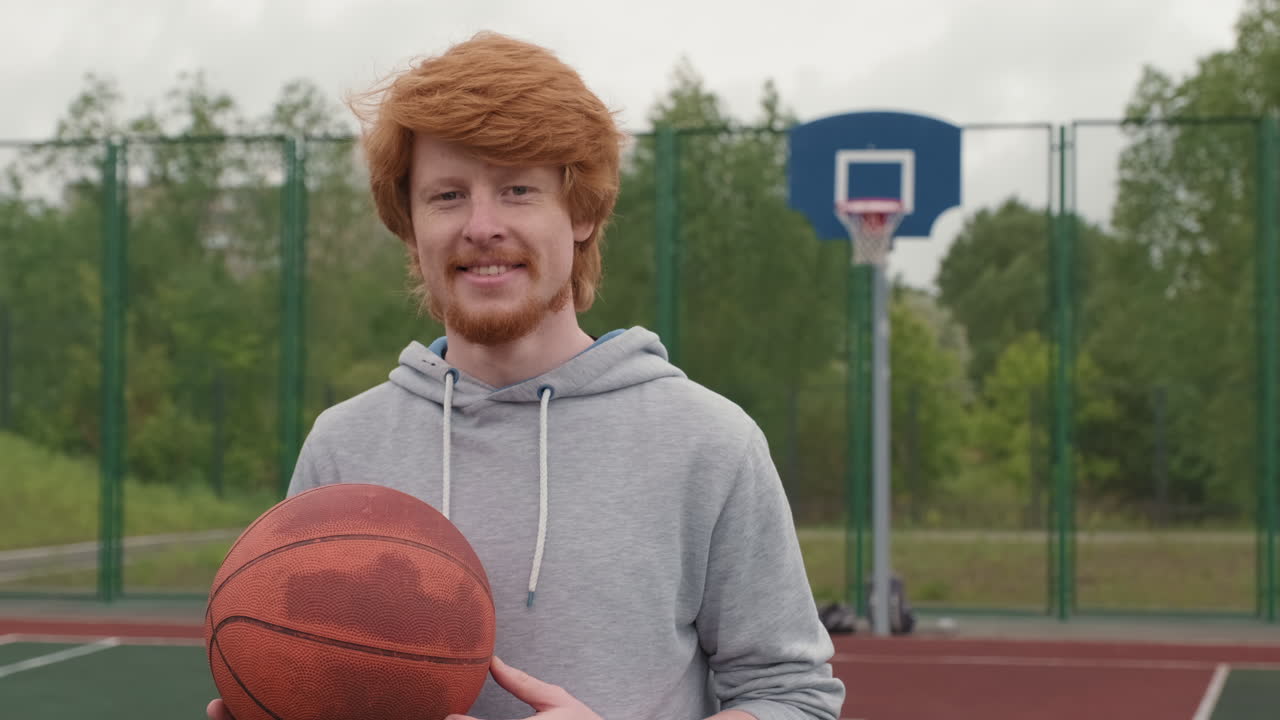 Man with basketball on outdoor court