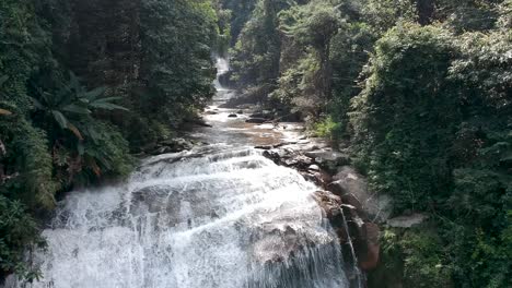 drone flying in a waterfall in chian mai thailand