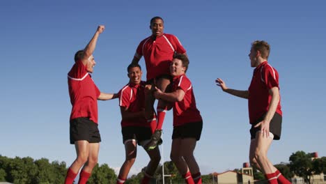 rugby players celebrating on the field