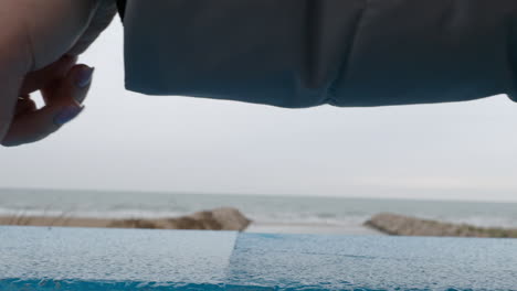 Female-fingers-walking-on-sea-background