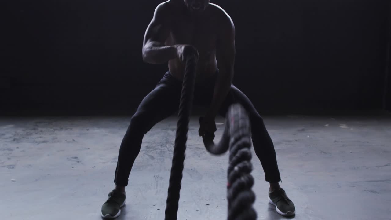 Athletes Training with Boxing and Battle Ropes in a Gym