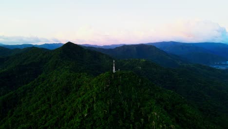 mount cagmasuso tower over hiking mountains in san andres, catanduanes, philippines. aerial drone shot