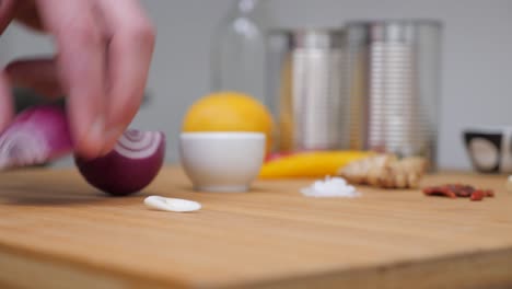 splitting a red onion in two, static camera