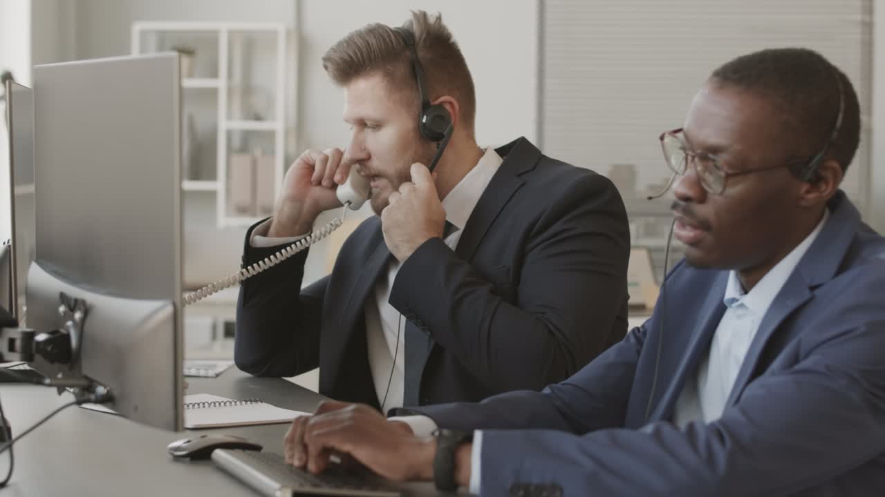 Two Diverse Stock Traders in Headsets Talking to Clients