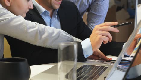 male and female hands of young coworkers showing potential places for business expansion on a part of world map. professional managers plan an international development sitting at table in office.