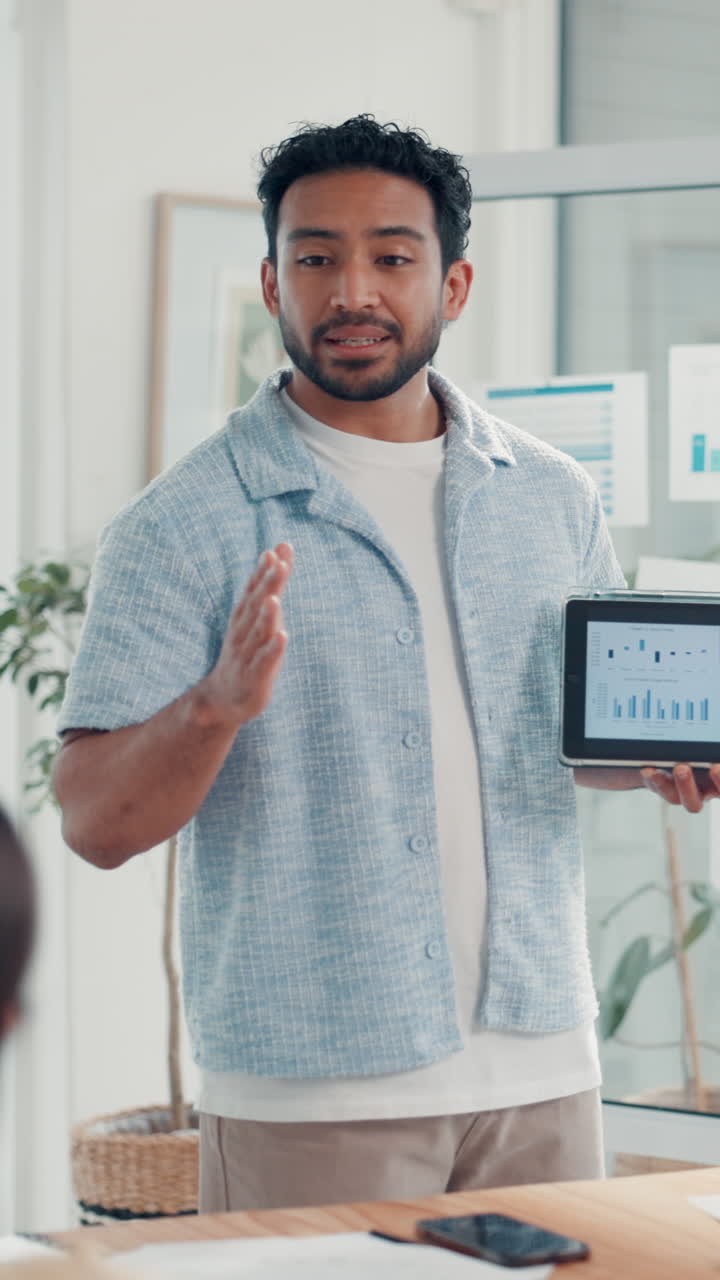 Man Presenting Business Data on Tablet in Office Meeting