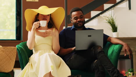 Couple-using-laptop-in-hotel-lobby