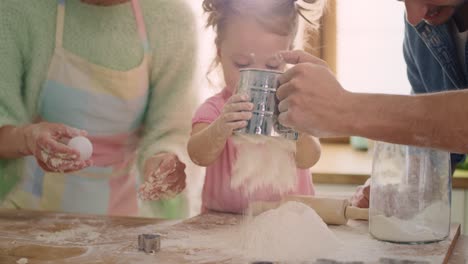 Handheld-view-of-little-girl-helping-parents-at-the-kitchen