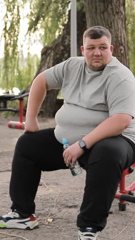 portrait face close up of a happy overweight young man smiling at camera outdoors tracking shot portrait face close up of a happy overweight young man smiling at camera outdoors tracking shot