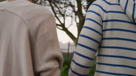 caucasian couple walking in a garden