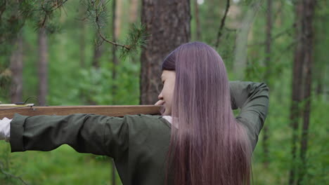 young-girl-takes-aim-to-shoot-crossbow