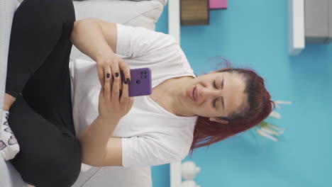Vertical-video-of-Happy-and-happy-texting-woman.