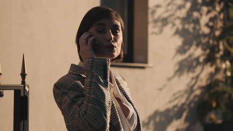 stylish woman making a business call outdoor.