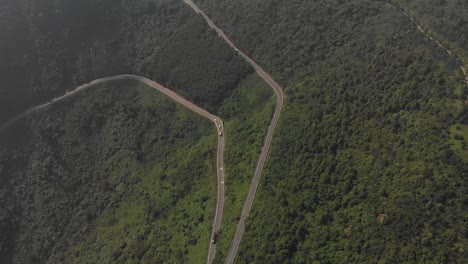 High-altitiude-aerial-drone-reveal-of-Hai-Van-Pass-mountain-range-in-Vietnam-on-long-road-trip-journey-through-the-vast-landscapes