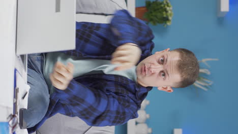 vertical video of home office worker man dances looking at camera.