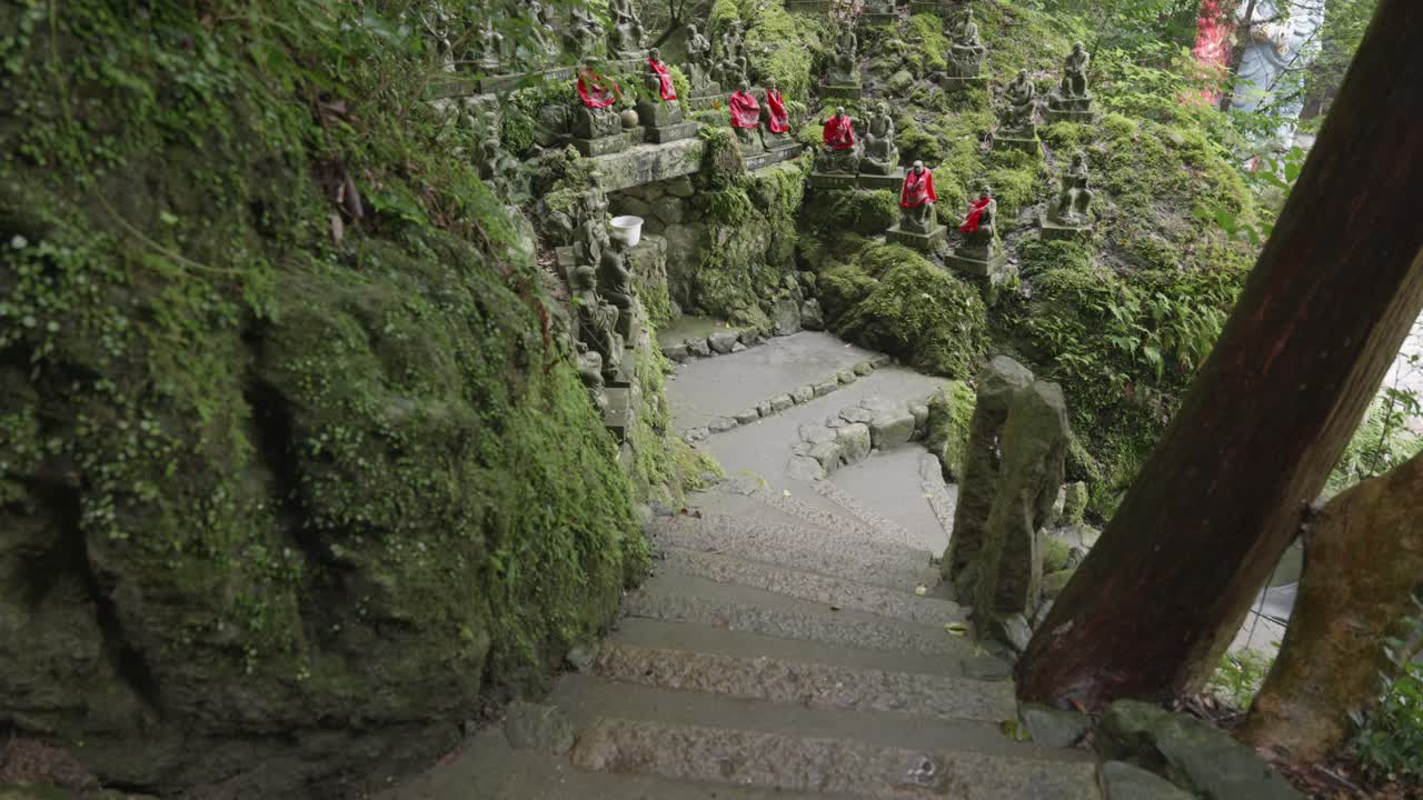 Small stone moss covered statues at Nanzoin temple, Fukuoka, Japan
