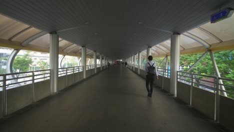 man walking down walkway