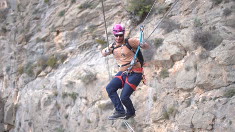 group of friends do via ferrata climb mountain with safety equipment in cartagena, region of murcia, spain