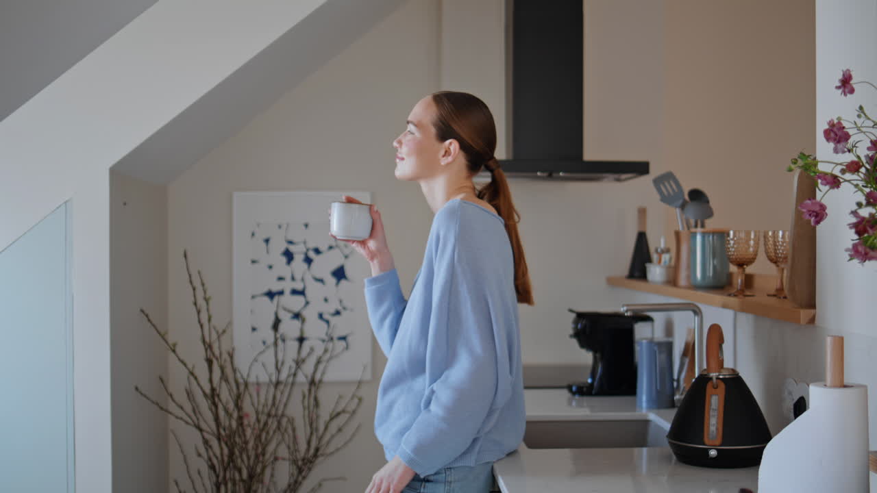 Home woman taking espresso in kitchen closeup. Relaxed lady drinking coffee