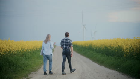 Farmer-With-Agronomist-On-Road-Amidst-Crops-At-Farm