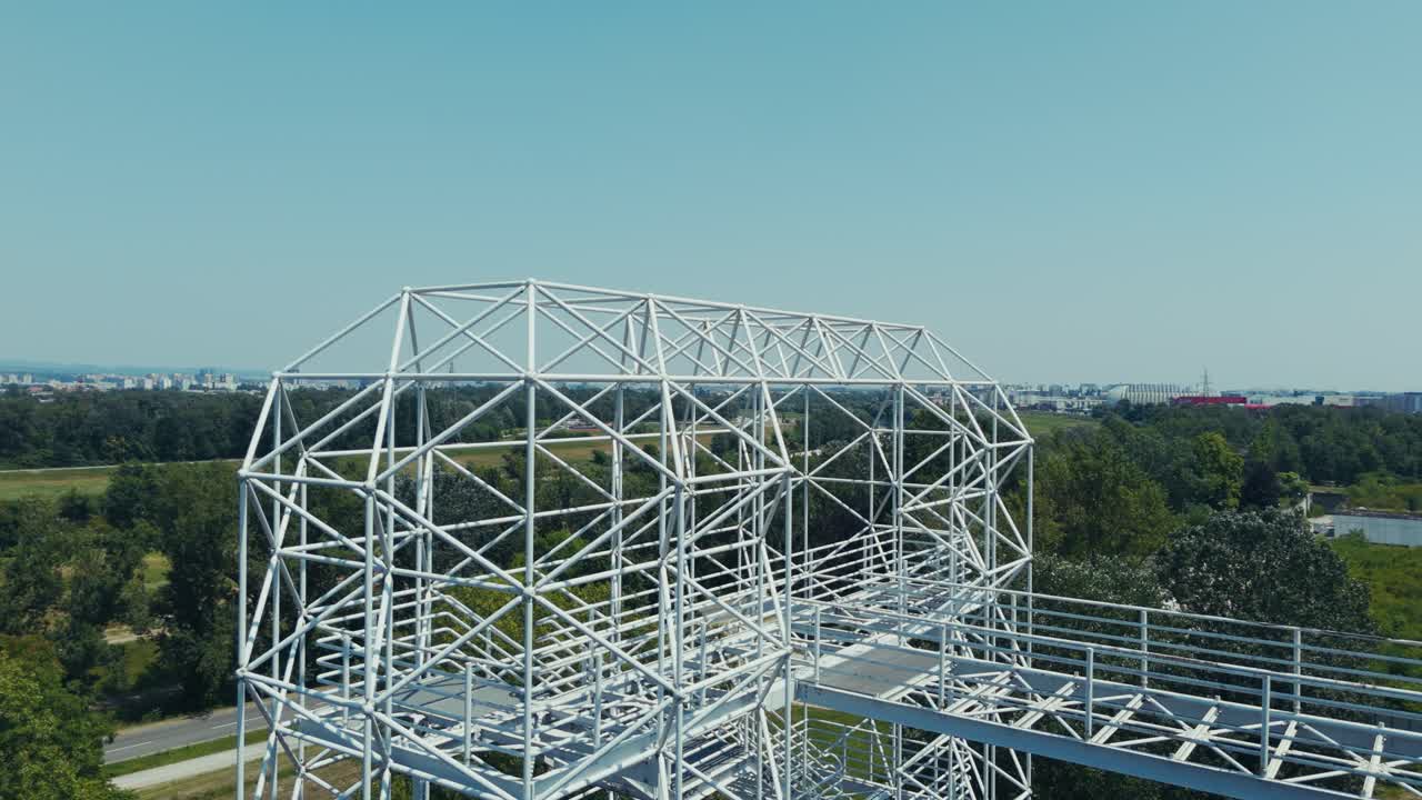 white metal framework rises from ruins of Zagreb’s overgrown hospital site