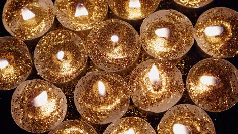 Background-of-tea-cup-glitter-Candles-Lights-shines-yellow-gold-bright-for-celebration,-religion,-anniversary-Festival