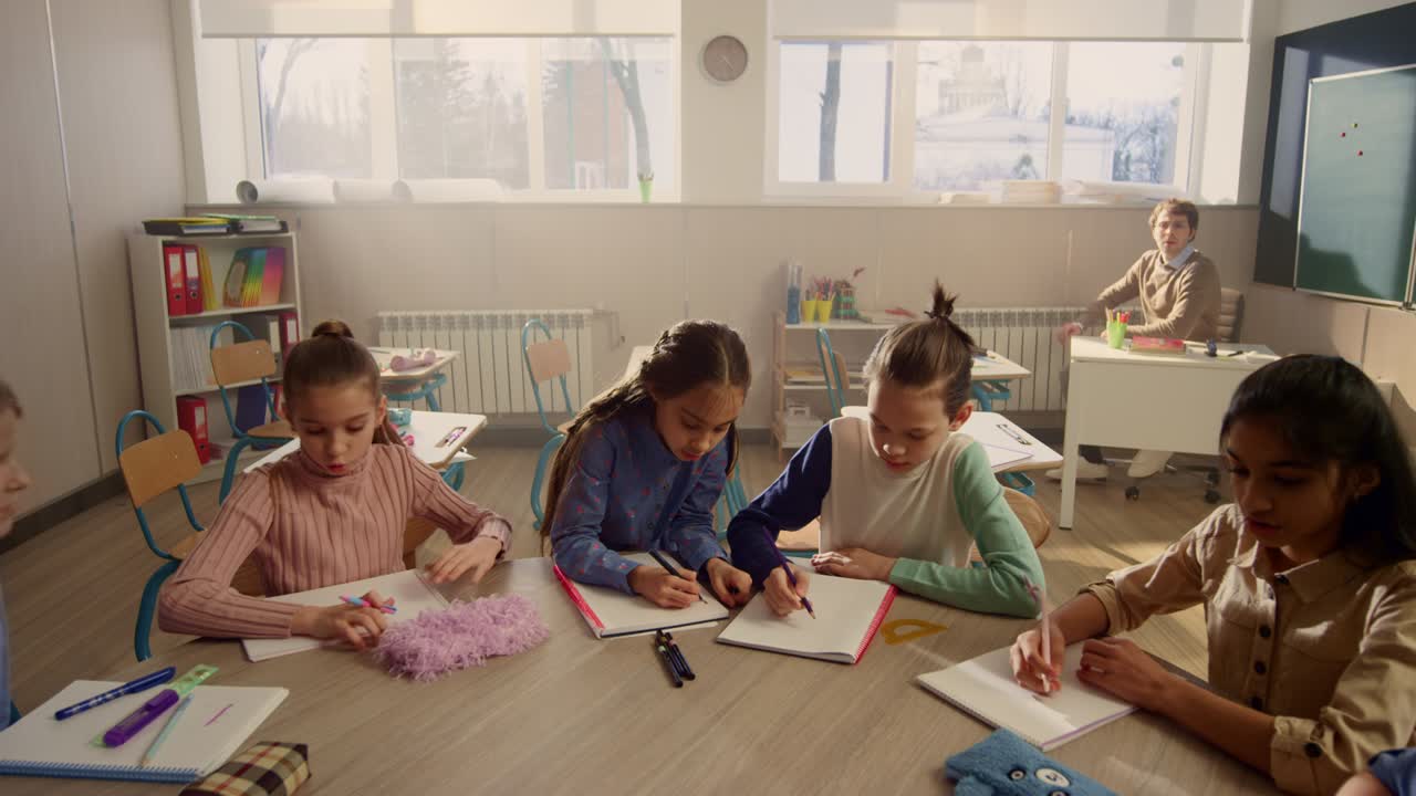 Students preparing for lesson in classroom. Teacher beginning lesson at school