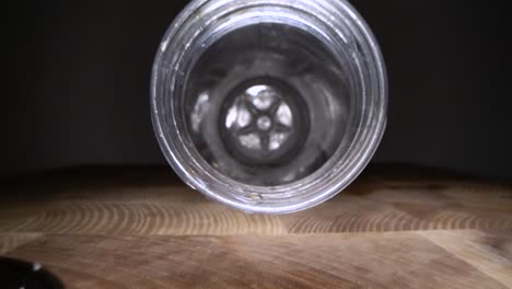 inside the plastic bottle. dolly macro shot of camera zooming in empty water bottle on wooden background