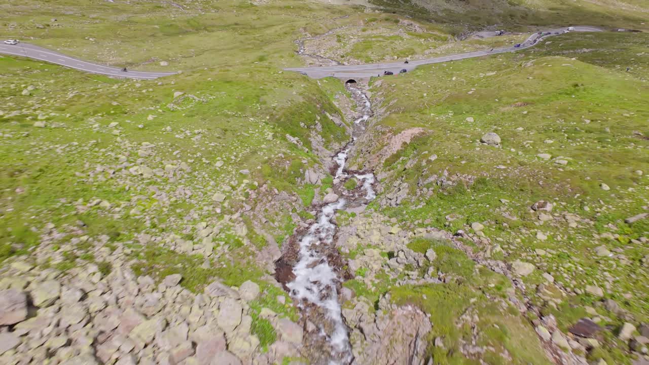 Rocky Mountains Covers with moss and flowing river downhill alps. Fpv drone shot