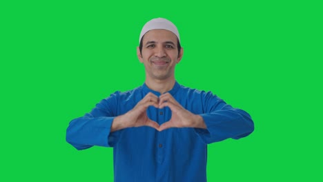 happy muslim man smiling and showing heart sign green screen